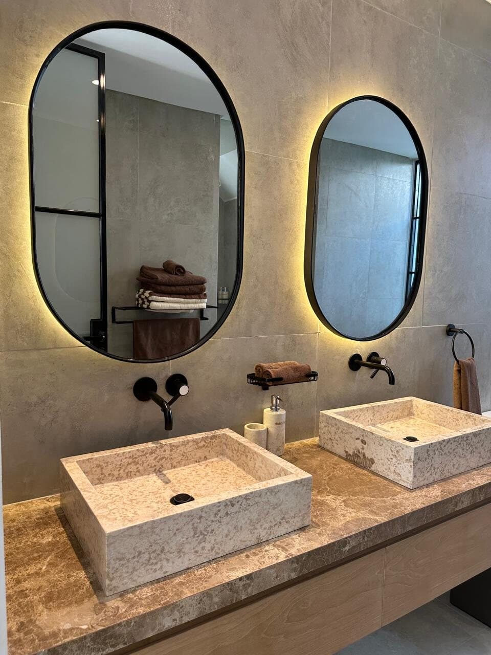 Twin stone basins under backlit oval mirrors, Umalas Villa 6